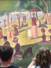 Young couple looking at Seurat.
